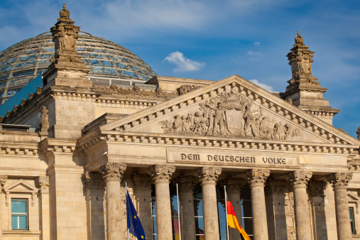 A close up picture of the German Parlament also knows as the Bundestag. The building itself is known as the Reichstag. The text \