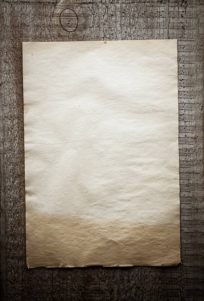 istock paper on wooden background 471328332