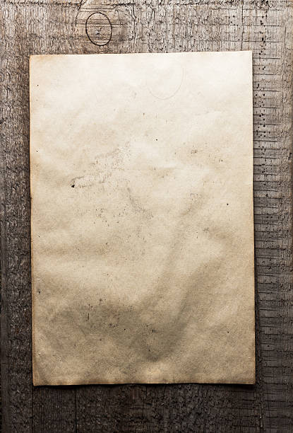 istock paper on wooden background 471328340