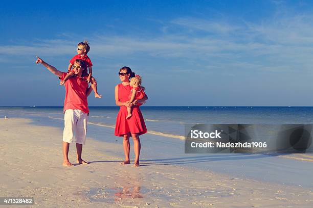 Young Family With Two Kids Walking At The Beach Stock Photo - Download Image Now - 2015, Adult, Baby - Human Age