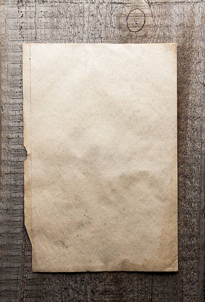 istock paper on wooden background 471328718
