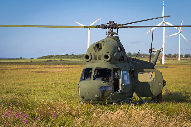 Soviet Helicopter Mi-2 in flight against Wind Turbines. Mi-2 - \