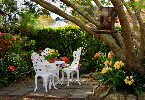 Garden furniture in a tranquil, lush garden setting during spring in Queensland, Australia