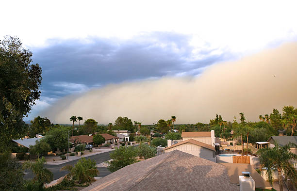 Dust storm rolling over residential area  Desert dust storm ("Haboob") rolling in across the city. dust storm stock pictures, royalty-free photos & images