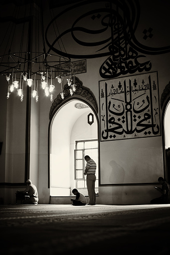 Bursa, Turkey - July 7, 2011: Men at different ages are praying in the Great Mosque