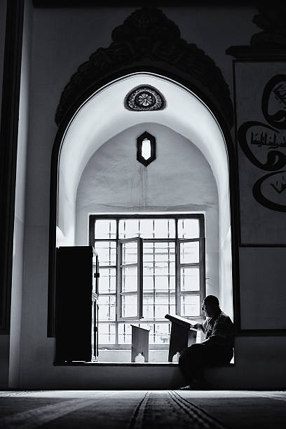 Prayer Bursa, Turkey - July 7, 2011: Old muslim man is reading Quran and praying in the Great Mosque koran photos stock pictures, royalty-free photos & images