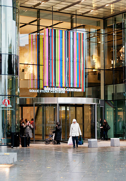 Entrance to the Sollentuna Centrum Shopping Mall - Stockholm, Sweden Sollentuna, Sweden - October 20, 2011: People outside the entrance to the Sollentuna Centrum shopping mall. The mall was extended and refurbished in 2010 and holds 120 shops and has 1500 parking lots for visitors. It is owned by Steen and Stroem Sweden AB (Corp) who runs 52 malls in Sweden, Norway and Denmark. sollentuna centrum stock pictures, royalty-free photos & images