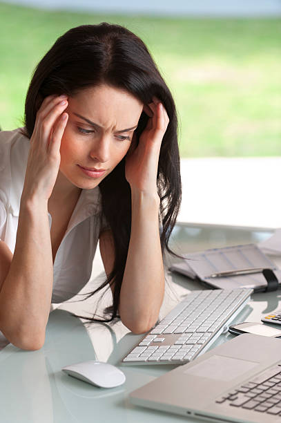 istock Attractive woman holding her head 471334245