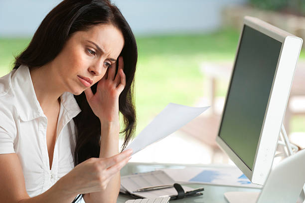 istock Woman looking worried reading a document 471334253