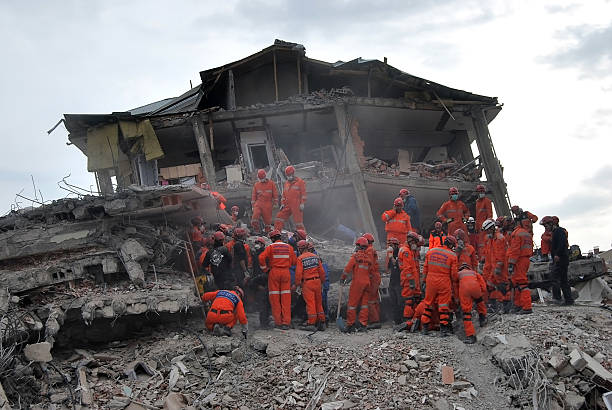 Earthquake in Turkey Van, Turkey - October 21, 2011: Rescue workers survey damage while searching for survivors December 21, 2011 in Van, Turkey. The 7.2 richter scale earthquake hit the Ercis, killing at least 600 people. earthquake stock pictures, royalty-free photos & images