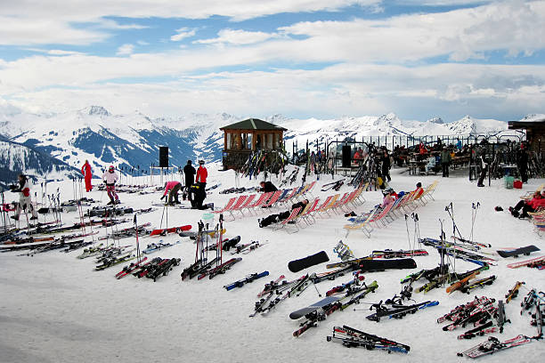 Saalbach, Austria - February 10, 2009: Mountain Summit at Saalbach-Hinterglemm, Austria. Skiers and a lot of equipment can be seen at the mountain summit, surrounded by a scenic view of the Alps.