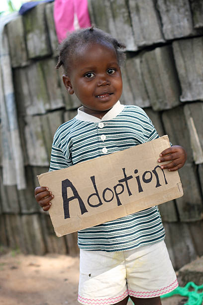 istock African Toddler with Adoption Sign 471335799