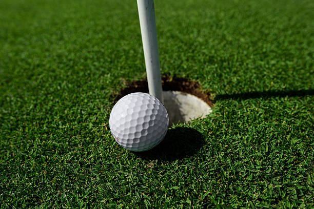 istock golf ball near hole 471336318