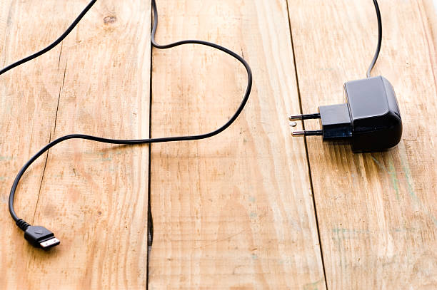 istock Black phone charger on a wood background 471336360