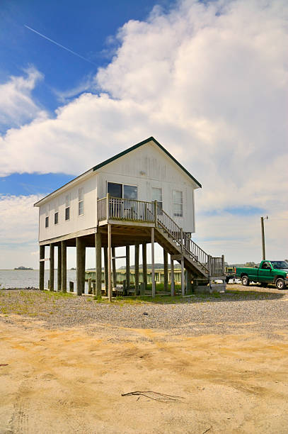 Maryland Eastern Shore Fishing Cabin A stilt house on Maryland's Eastern Shore is used as a fishing shack by weekend fishermen. Quite an elaborate "shack"! stilt house stock pictures, royalty-free photos & images