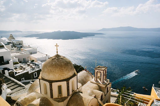 A lovely church in Fira, the capital of Santorini, with view to the volcano and caldera.
