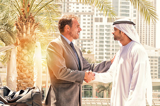 istock Middle eastern businessmen meeting western man 471336700
