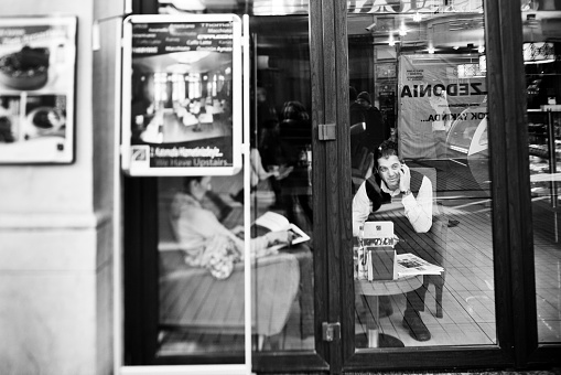Istanbul, Turkey - November 5, 2009: A man talks on his cell phone while sitting in a cafe.