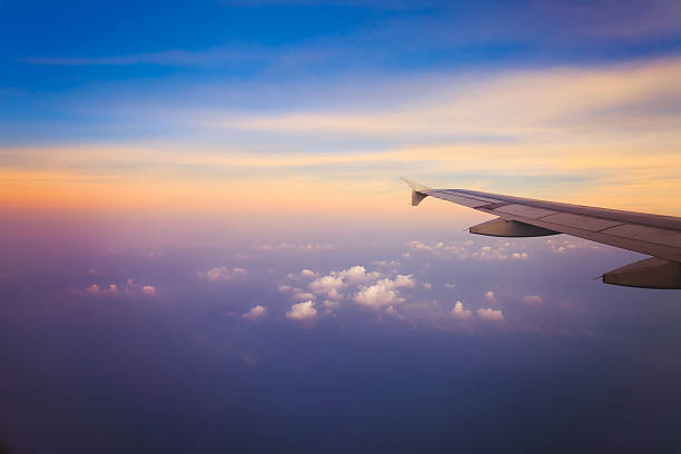 istock Airplane in the sky at sunrise 471337474