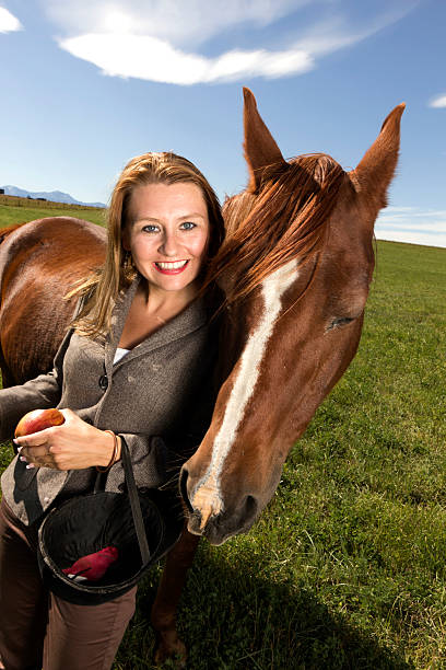 An image of a woman and horse.