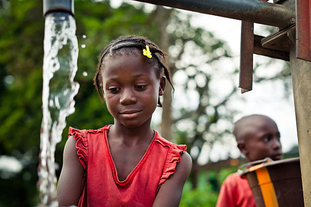 istock African Girl By Water Pump 471339359