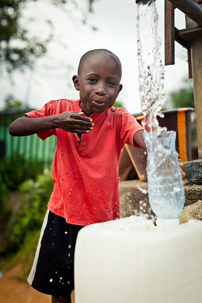 istock African Boy By Water Pump 471339385