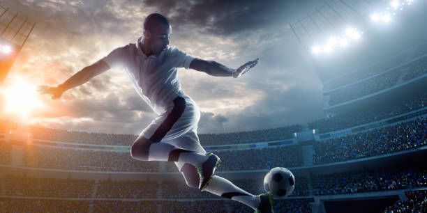 istock Soccer player kicking ball in stadium 471340292