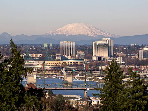 Portland Oregon Willamette River Bridges City Skyscrapers Mt St Helens A view looking down to the Willamette River with trees, bridges, Convention Center, Skyscrapers and Mt St Helens (Washington State) in the background. This is  downtown Portland, Oregon area. mount st helens stock pictures, royalty-free photos & images