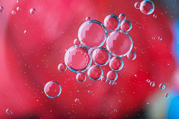 istock Abstraction of oil droplets on water surface 471341374