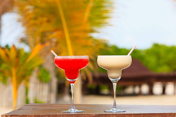 istock Two cocktails on tropical sand beach 471341426
