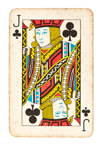 Oslo, Norway - June 4, 2015: Vintage playing card with illustration of colourful,blue, red and yellow joker with jester hat.