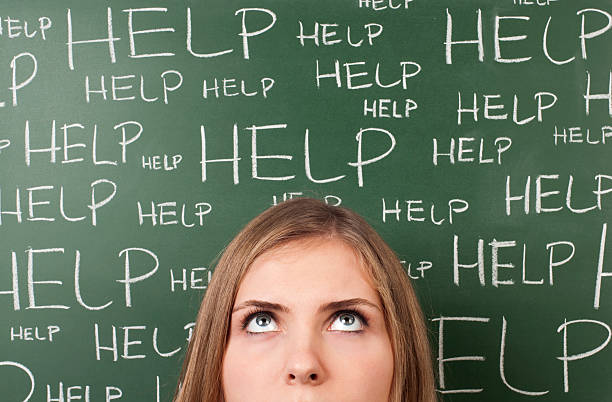 istock A thoughtful woman in front of a board with the words 'HELP' 471342081