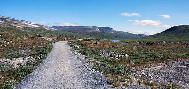 Panorama dirt road between mountain cabin Glitterheim and parkinglot (Jotunheimen, Norway)