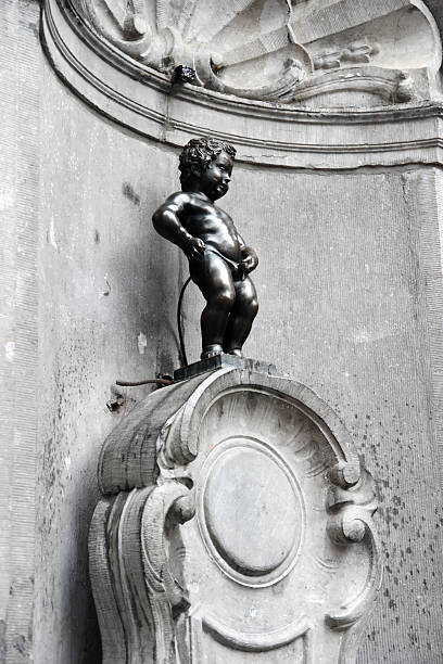 Brussels Mannekin Pis The 61cm tall statue of "Mannekin Pis" in Brussels. This famous Brussels landmark was made in 1619. manneken pis statue in brussels belgium stock pictures, royalty-free photos & images