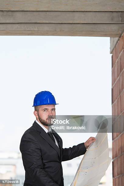Portrait Of Happy Young Foreman With Hard Hat Stock Photo - Download Image Now - 2015, Adult, Adults Only