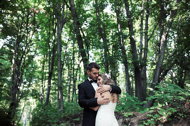 istock Beautiful wedding couple posing in forest 471344866