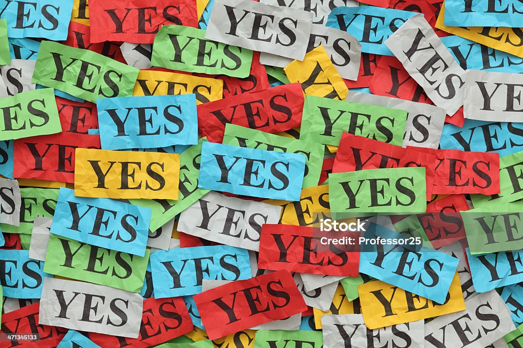 Yes Pile of сrumpled colorful paper notes with word "Yes". Yes - Single Word Stock Photo