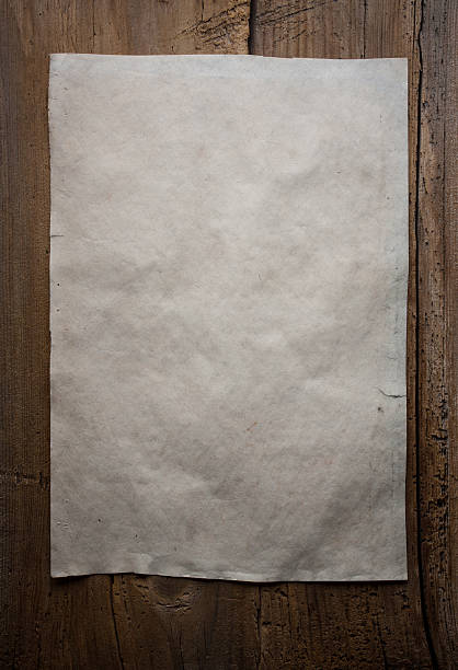 istock paper on wooden background 471345516