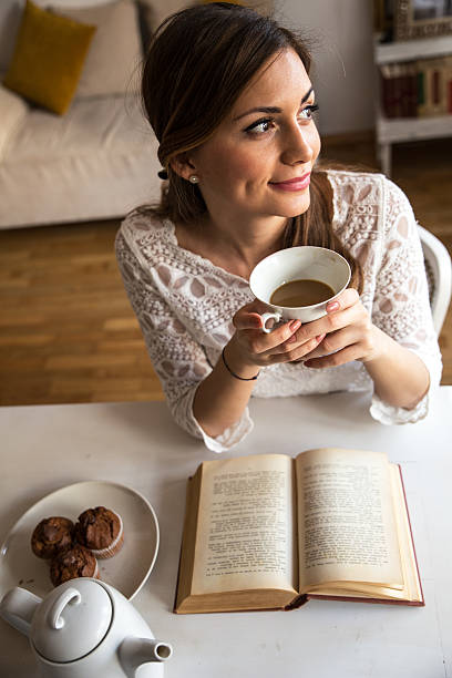 istock Beautiful middle age woman drink coffee at home 471345570