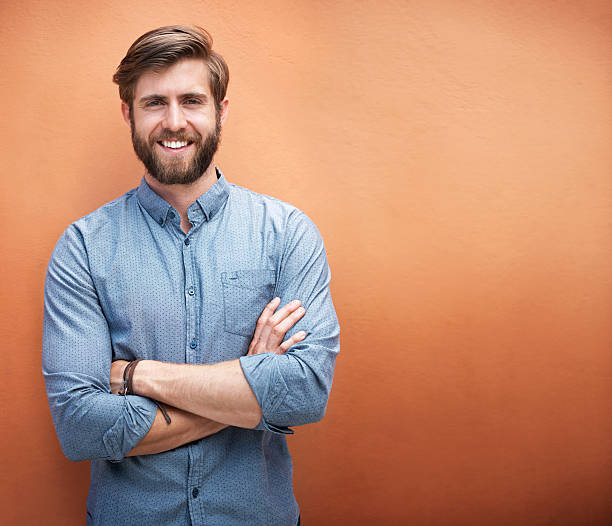 He's got style and a great smile Cropped portrait of a trendy young man standing against an orange backgroundhttp://195.154.178.81/DATA/i_collage/pu/shoots/799434.jpg facial hair photos stock pictures, royalty-free photos & images