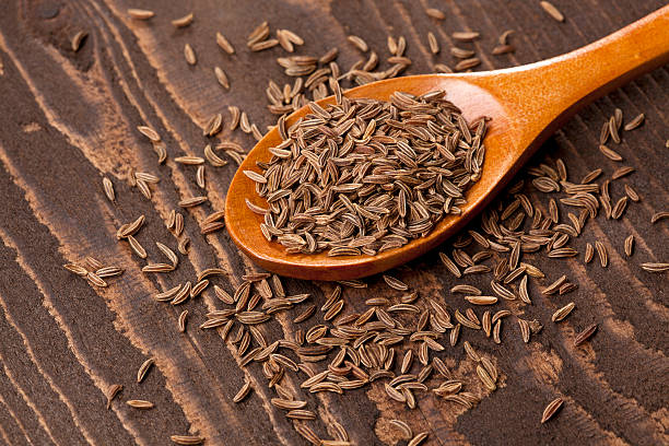 istock Caraway seed in wooden spoon 471346193