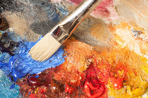 istock Paintbrush with oil paint on a classical palette 471346707