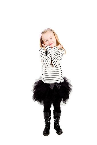 Cute 4 year old little girl standing up wearing back tutu