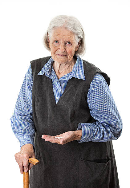 istock Senior woman holding medications over white 471347621