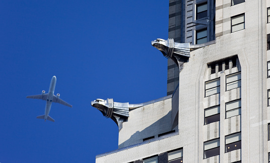 New York City, USA - September 1, 2010: Airplane flying over Manhattan, with the Chrysler Building in the foreground.