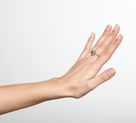 the ring is held with the fingers, demonstrating the diameter of the ring and its type. jewelry in a woman's hand.