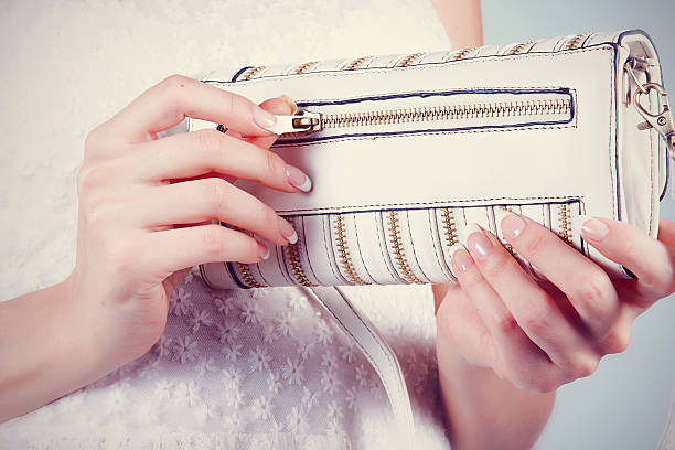 istock Female hands with manicure with small white handbag 471349404