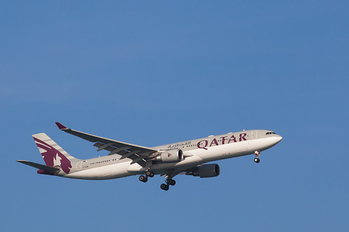 Doha, Qatar - January 2, 2012: One of Qatar Airways Airbus A330 on its way down for landing in Doha. Headquartered in Doha, Qatar Airways operates a hub-and-spoke network, linking over 100 international destinations from its base in Doha, using a fleet of over 100 aircraft.