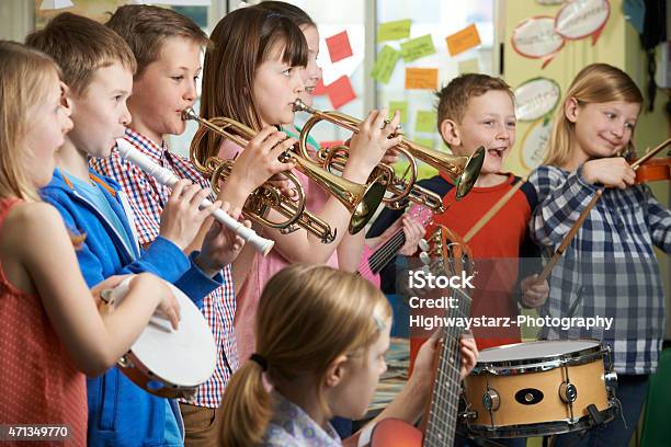 Group Of Students Playing In School Orchestra Together Stock Photo - Download Image Now