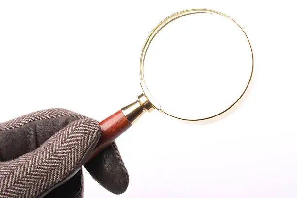 Detective usinq magnifying glass isolated on white background.
